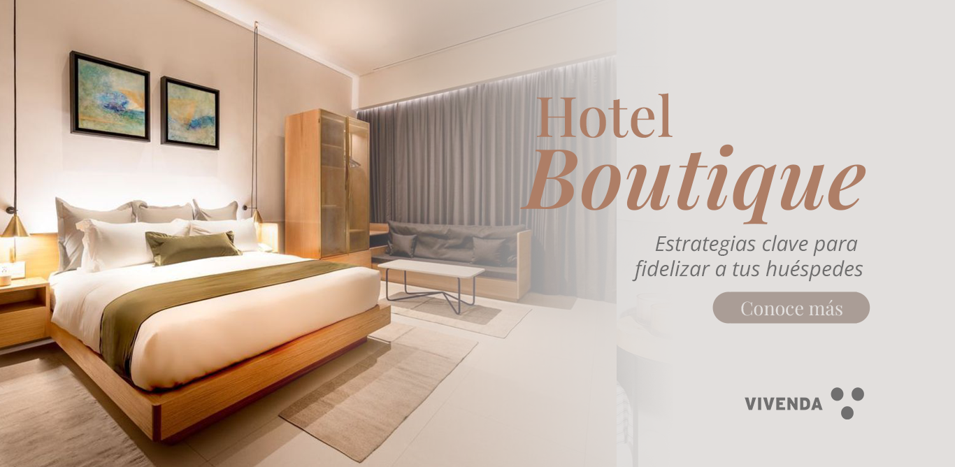 Cama de hotel boutique vestida con ropa de cama de lujo Vivenda, transmitiendo exclusividad, confort y fidelidad del huésped.